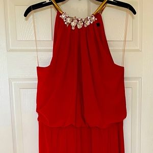 Red long formal dress with jewels and gold necklace